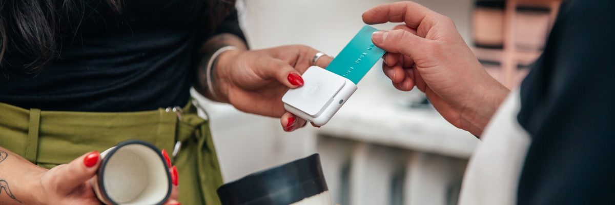 merchant-taking-sale-with-chip-and-swipe-reader
